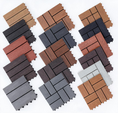 A variety of interlocking composite deck tile samples in different colors and patterns including brown, red, gray, and charcoal WPC tiles