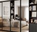 modern mirrored closet door with a slim black frame in a minimalist bedroom