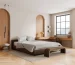 Light natural oak hardwood flooring in a modern minimalist bedroom with warm sunlight.