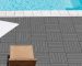 Barefoot person walking safely on a splinter-free grey WPC composite deck tile surround next to an outdoor swimming pool